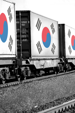 Train Freight transportation. Cargo transit. Summer Day. Container textured by flag of the South Koreaの写真素材