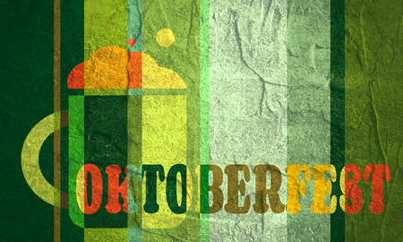 Mug of beer and Oktoberfest word on striped green backdrop.の写真素材