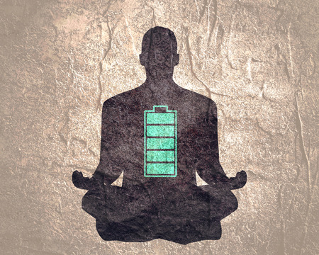 Businessman in with battery icon. Full battery concept. Business and life energy. High full level energy battery. Man sit in meditation pose.の写真素材