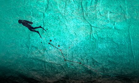 Cutout silhouette of diver. Lines connected with dots trail. The concept of sport diving.の写真素材