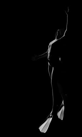 Diving sport concept. Human silhouette on dark backgroundの写真素材