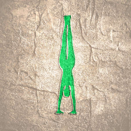 Sporty beautiful young woman working out, doing handstand. Yoga and fitness training themeの写真素材