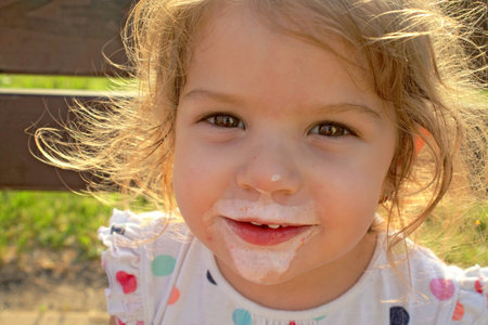 The girl enjoying an ice-creamの写真素材