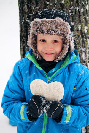 Boy and white heartの写真素材