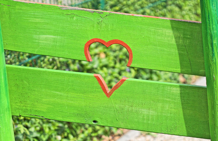 red heart on green fenceの写真素材
