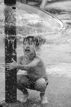 The boy plays with waterの写真素材