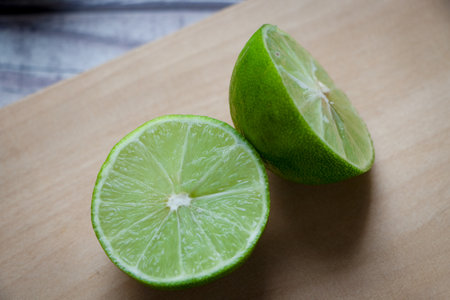 A lemon cut in half on a chopping board. Everything is on a rustic gray table.の写真素材