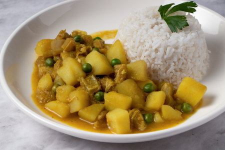 Cau Cau, Peruvian food. Cau cau is a typical dish of Peruvian food, which is made from mondongo or beef stomach. It is accompanied by white rice. Served on a plateの写真素材