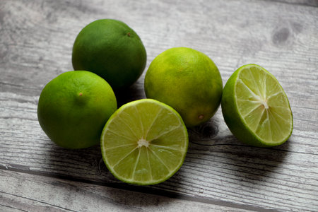 lemons on a rustic gray table, one of the lemons is cut in half.の写真素材
