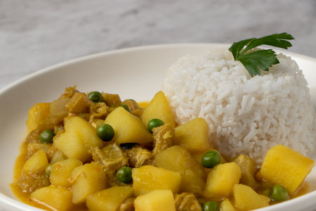 Cau Cau, Peruvian food. Cau cau is a typical dish of Peruvian food, which is made from mondongo or beef stomach. It is accompanied by white rice. Served on a plateの写真素材