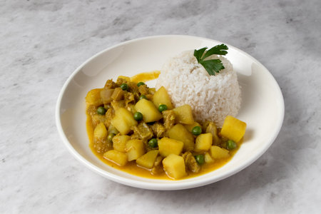 Cau Cau, Peruvian food. Cau cau is a typical dish of Peruvian food, which is made from mondongo or beef stomach. It is accompanied by white rice. Served on a plateの写真素材