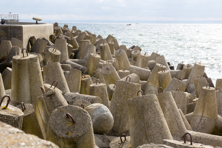 Concrete breakwaters piled on the seashoreの写真素材