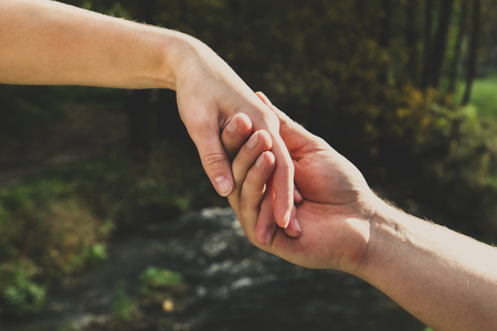 A man's hand holds a woman's handの写真素材
