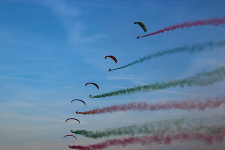 Paragliding with colored smoke behindの写真素材