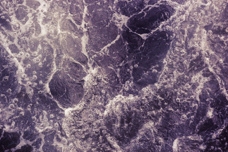 The surface of the sea with waves, foam and bubbles, purple abstract backgroundの写真素材