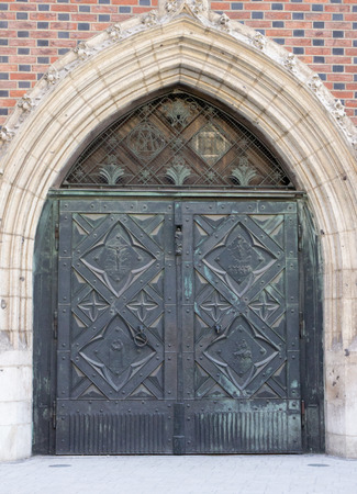 The vintage black metal front door of an old houseの写真素材