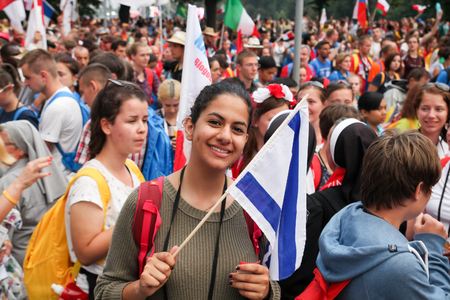 KRAKOW, POLAND -  2016 - World Youth Day 2016, A crowd of people, a young girl with a flag smilesのeditorial素材