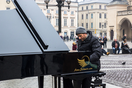 KRAKOW, POLAND, January 27, 2017  A street musician Arne Schmitt plays the piano on the main Rynok square in Krakowのeditorial素材
