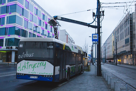 KRAKOW, POLAND, January 28, 2017 electric bus is charging at a bus stop in the cityのeditorial素材