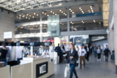 Many People and buyers go inside a large shopping mall, a lot of shops, blurred concept