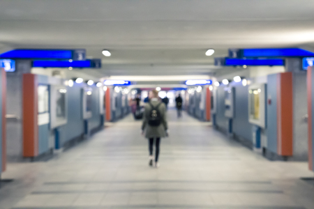 The terminal of the railway station, the tourist  walking along the tunnel in search of the peron, blurred conceptの写真素材