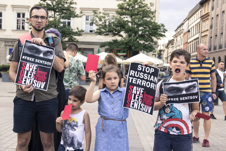 Krakow, Poland, June 01, 2018, A group of children with parents holding posters and red cards protest against Russian political prisoners and for the release of Oleg Sentsovのeditorial素材