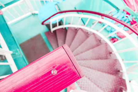 Pink coral and green pastel modern spiral staircase descentの写真素材