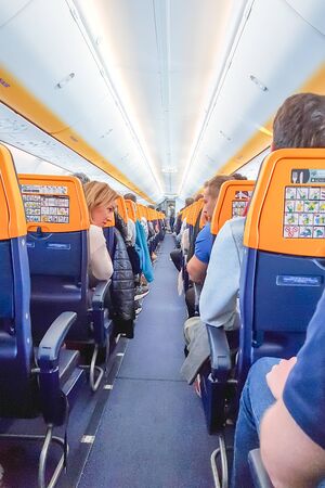ROME, ITALY - APRIL 09, 2019: People on the board of Ryanair Planeのeditorial素材
