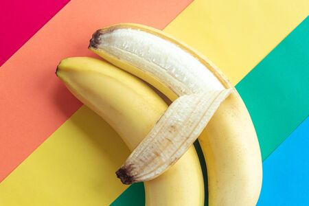 LGBT love concept, two bananas lie on the rainbow flag, a symbol of male love, close-upの写真素材