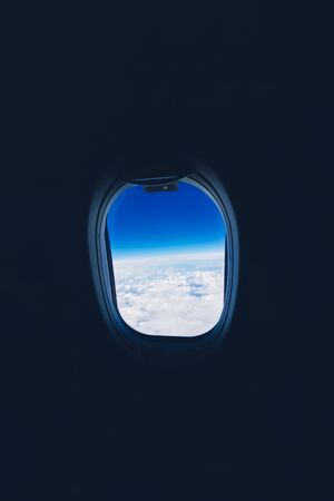 View from the plane window to the clouds and sky during the flightの写真素材