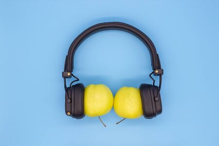 Two apples in the headphones, the concept of sharing music, friendship, love and spending time togetherの写真素材