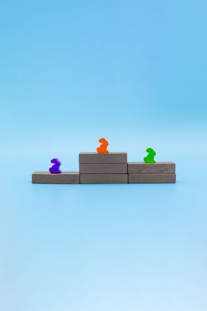 Victory podium, concept of occupation of the first, second and third places, wooden rabbits on a...