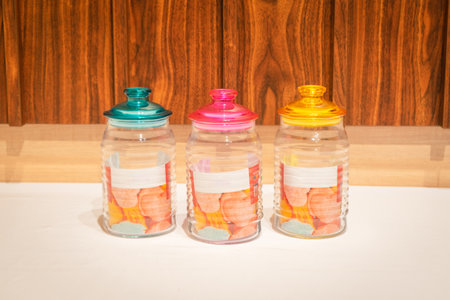 Colorful Glass Jars with Lids are perfect for storing and organizing a variety of items. With their vibrant hues and practical design, they offer a stylish way to brighten up your storage space. Whether you use them to store kitchen essentials, bathroom items, or office supplies, these jars are both functional and decorative.の写真素材