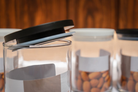 Black and White Glass Jars with Lids are a stylish and practical storage solution for any home. Made of high-quality glass, these jars come with tight-fitting lids that keep your food items fresh and protected from dust and insects.の写真素材