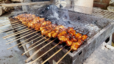 Grilling chicken satay in the afternoon is a great way to enjoy the warm weather while indulging in a delicious meal.の写真素材