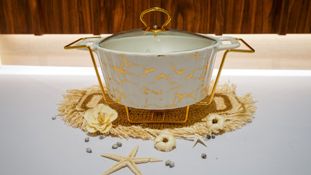 The White Ceramic Buffet Pot is a stylish and functional solution for serving large meals at parties, events, or family gatherings. This spacious pot can hold large quantities of food and keep it warm for extended periods of time.の写真素材