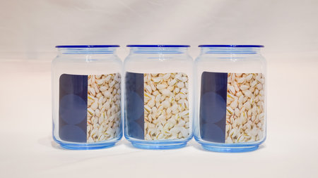 The Set of Three Blue-Lidded Jars is a charming and functional addition to any storage space. These jars come in a set of three, each with a blue lid that adds a pop of color to your decor.の写真素材