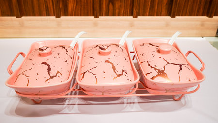 This pink ceramic vegetable bowl is a stunning addition to any kitchen.の写真素材