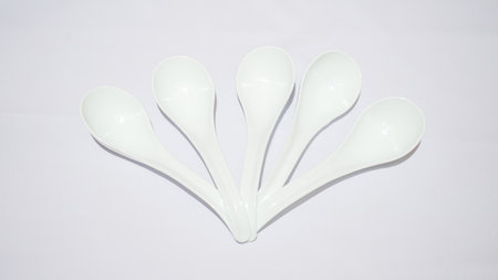 A white ceramic spoon is a versatile and stylish addition to any kitchen or dining room. It is made of high-quality ceramic material that is durable and long-lasting.の写真素材