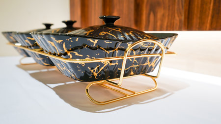 This black ceramic rectangular vegetable bowl is a stunning addition to any dining table.の写真素材