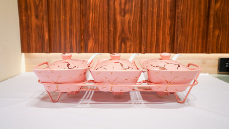 This pink ceramic vegetable bowl is a stunning addition to any kitchen.の写真素材