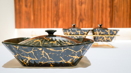 This black ceramic rectangular vegetable bowl is a stunning addition to any dining table.の写真素材