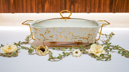 This Rectangular White Ceramic Vegetable Container with Gold Motif is a stunning addition to your...