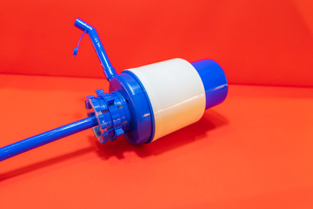 The Blue Water Jug Pump is a convenient and efficient water dispenser designed to fit on top of standard water jugs.の写真素材