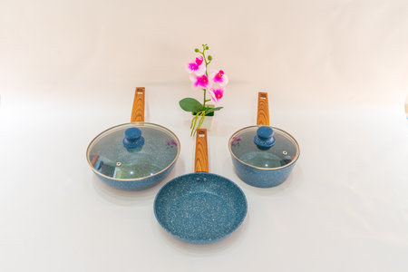 The Blue Non-Stick Pot and Teflon Pan with Wooden Handle is a versatile and convenient cookware set that combines functionality with style.の写真素材