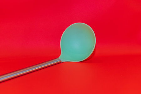 The Green Vegetable Spoon is a vibrant and versatile utensil designed for enjoying healthy meals.の写真素材