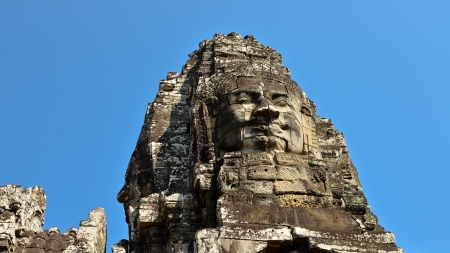 Smiling Stone Face in a Tower of Bayon Temple - Angkor Thom, Cambodiaの写真素材