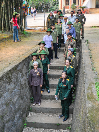 Quang Tri, Vietnam - Apr-15-2011: North Vietnam Army veterans of the Vietnam-American war gather by the steps of Entrance 13 to Vin Moc tunnels to commemorate their wartime sacrifices and struggles.のeditorial素材