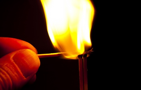 burning match on black background