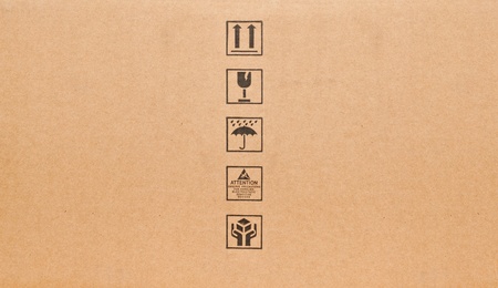 Fine image close-up of black fragile symbol on cardboardの写真素材